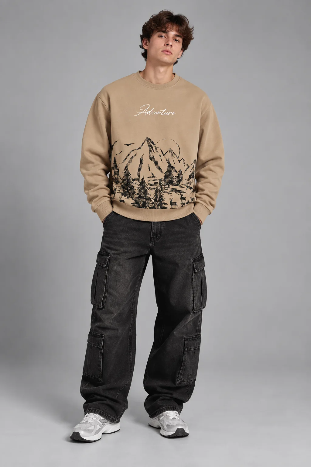 Model wearing a beige adventure mountain graphic sweatshirt