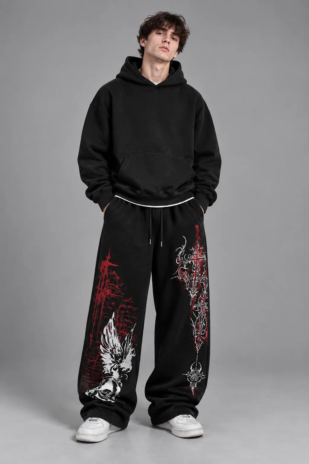 Model wearing black wide-leg sweatpants with red and white gothic graphics