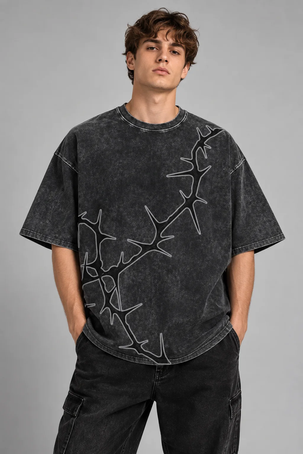 Model wearing a charcoal oversized acid-wash graphic T-shirt