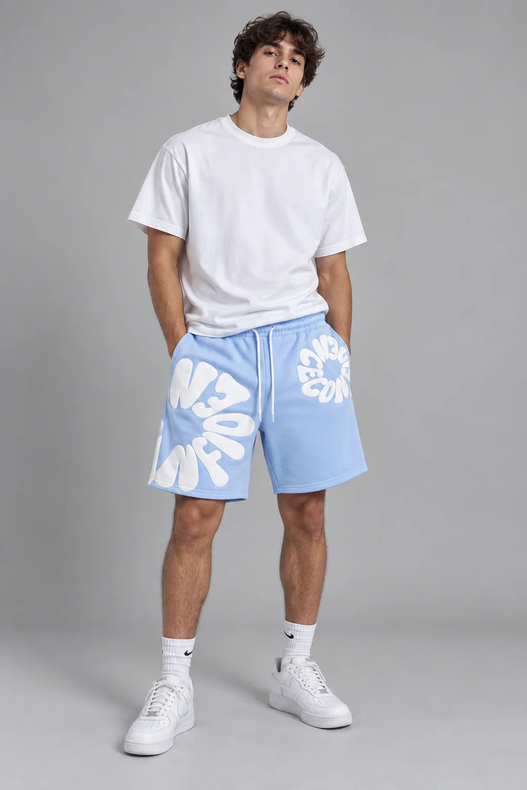Model wearing light blue oversized graphic sweatshorts