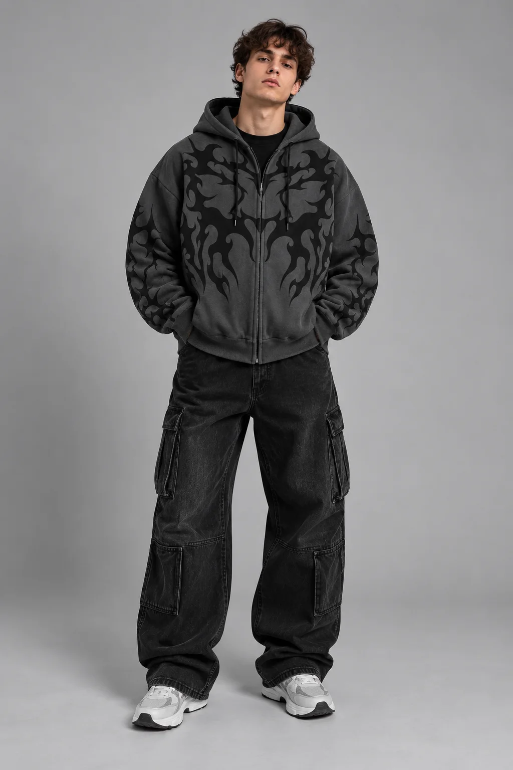 Model wearing a charcoal oversized tribal graphic zip-up hoodie