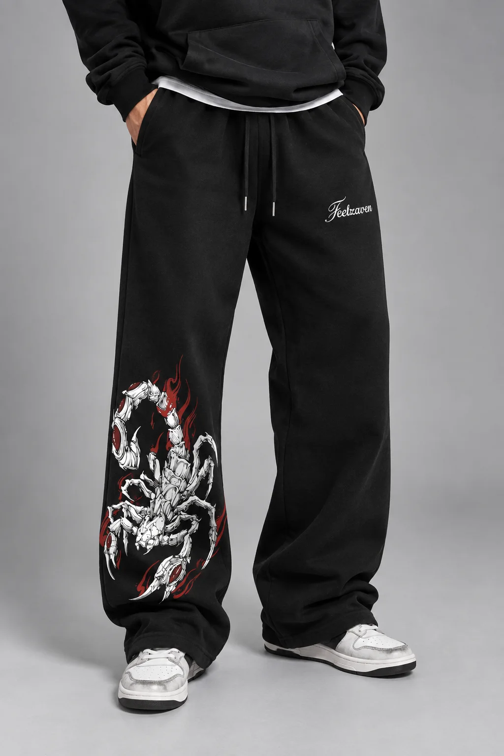 Model wearing black wide-leg joggers with a scorpion graphic